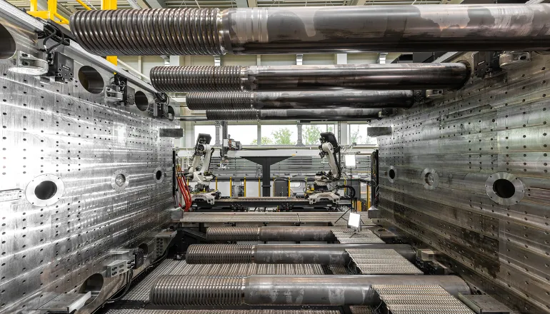 Image shows large open mold space with two large platens on the left and right