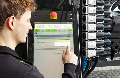 Picture shows machine operator using the iQ hold control software
