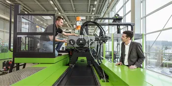 Picture shows service technician at an ENGEL injection moulding machine