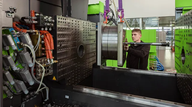 Picture shows open mould area for retooling the injection moulding machine