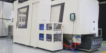 Picture shows white, compact injection moulding production cell in clean room design from ENGEL