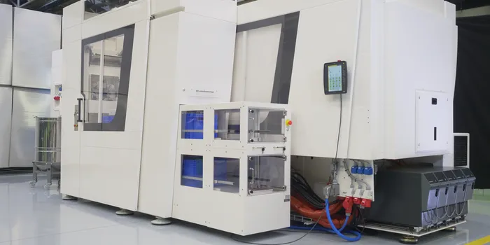 Picture shows white, compact injection moulding production cell in clean room design from ENGEL