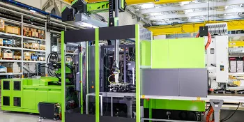 Image shows complete injection moulding system including automation and conveyor technology from a single source