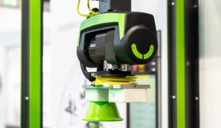 Close-up of the ENGEL viper robot gripper removing an injection-molded part
