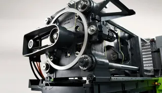 Picture shows clamping side of small injection molding machine