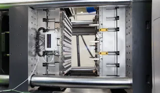 Picture shows mold area of a toggle injection molding machine from ENGEL