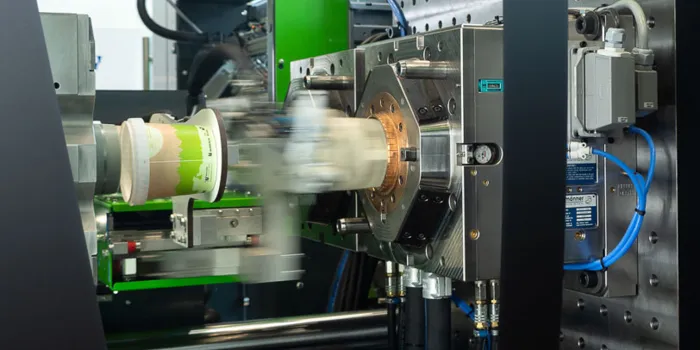 Picture shows injection moulding production of a thin-walled bucket with short injection moulding machine dry cycle time