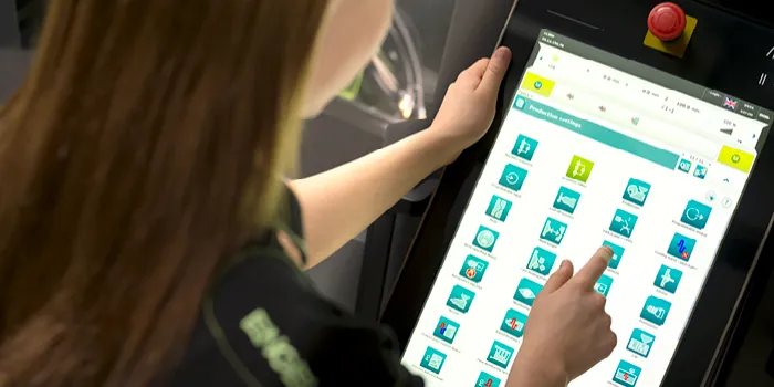 Picture shows machine operator at ENGEL injection moulding machine control unit