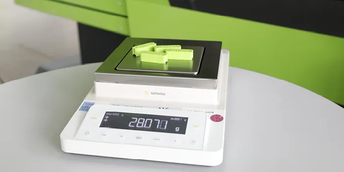 Picture shows scale for measuring the weight of a plastic component