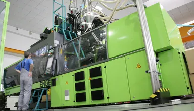 Picture shows tie-bar-less injection moulding machine
