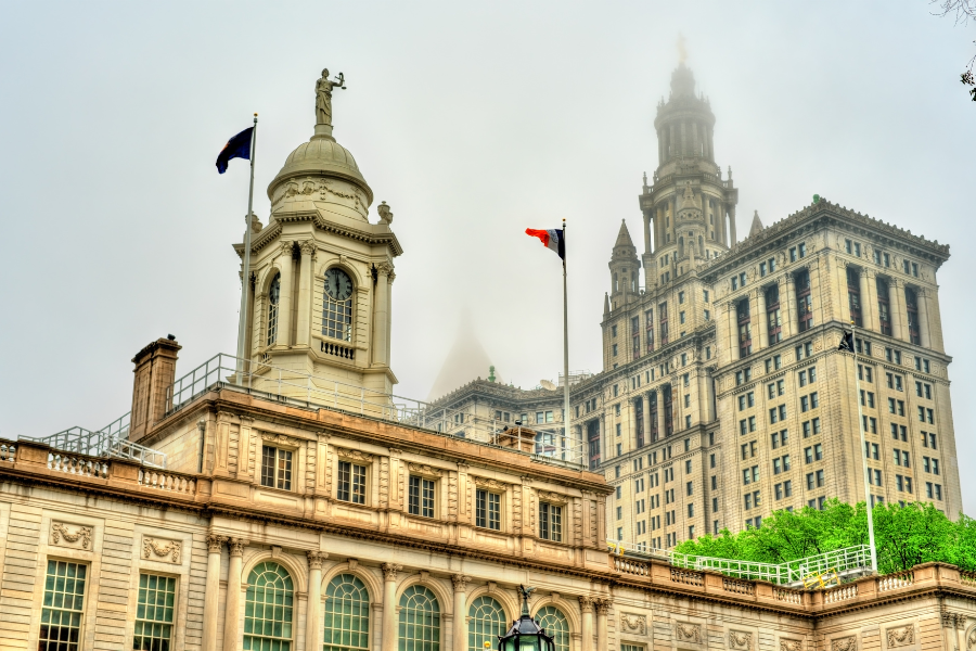 NYC Town Hall building, partially obscured by fog in the background.