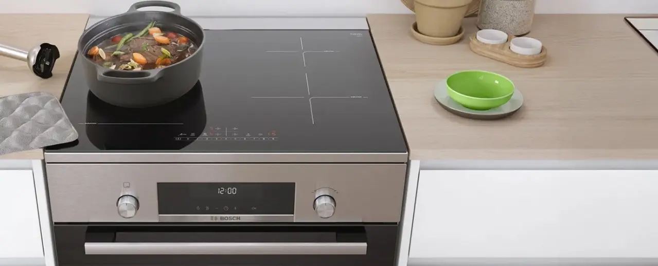 Bosch free-standing induction hob on which a pan of food is cooking.