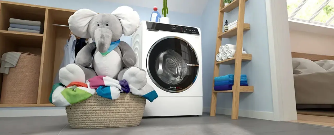 Bosch washer dryer and laundry basket with large plush elephant in it.