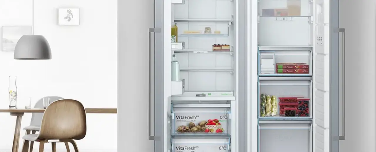Fridge-freezer with VitaFresh drawers and open doors.