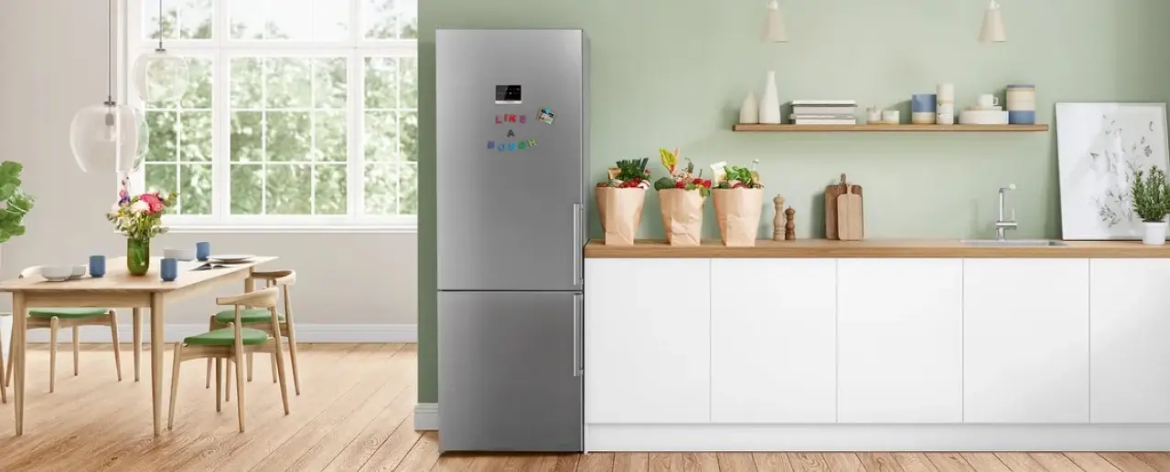 Bosch free-standing fridge in a cheerful kitchen with flowers.