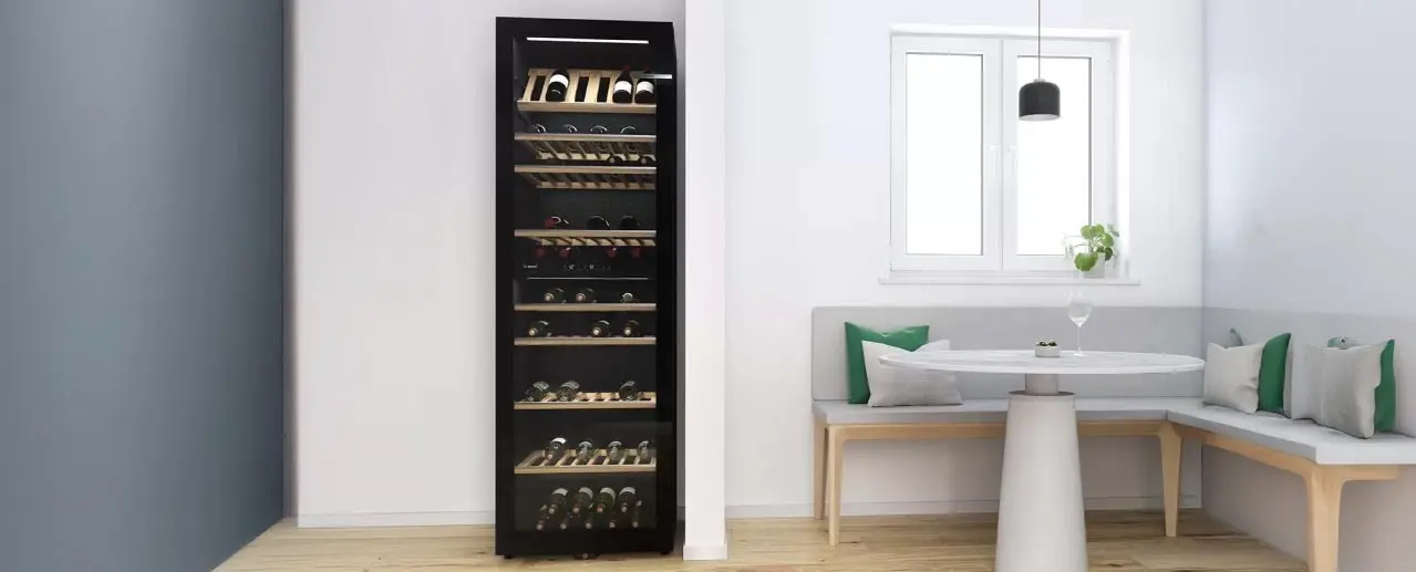 Large black Bosch wine cooler in a living room with a white, green and wooden seating area.