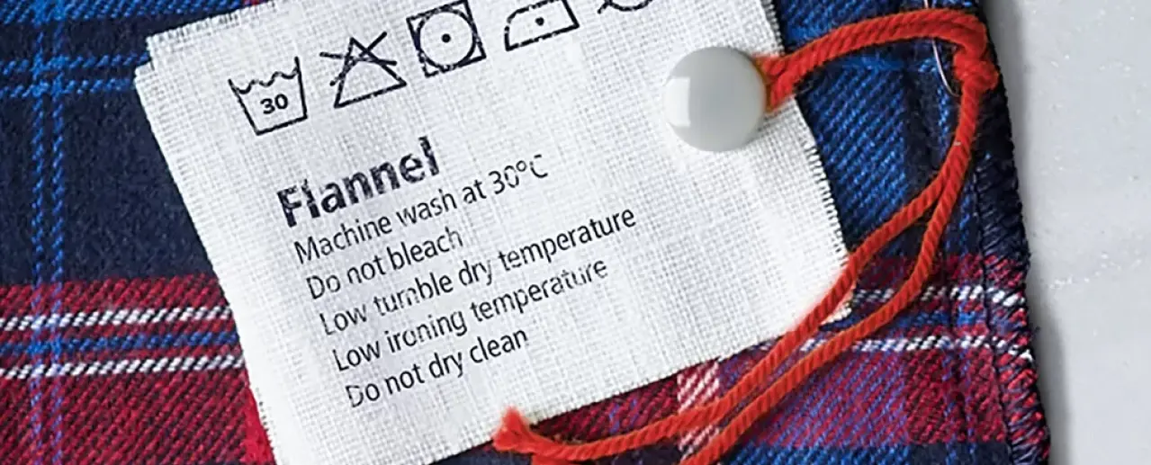 Washing label with symbols and washing instructions.