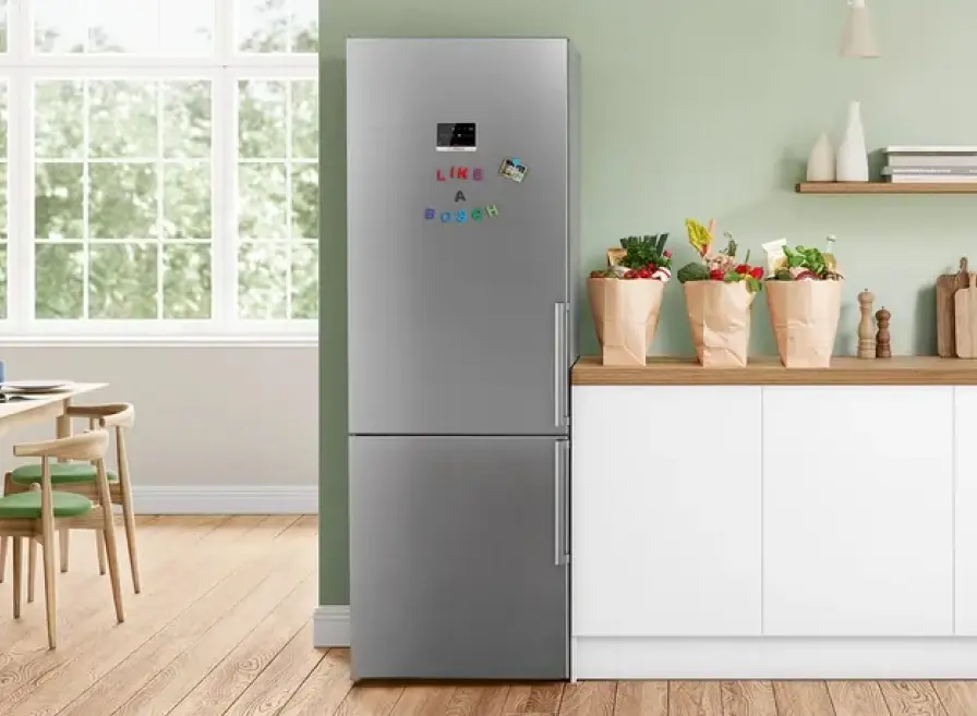 Bosch free-standing fridge in a cheerful kitchen with flowers.