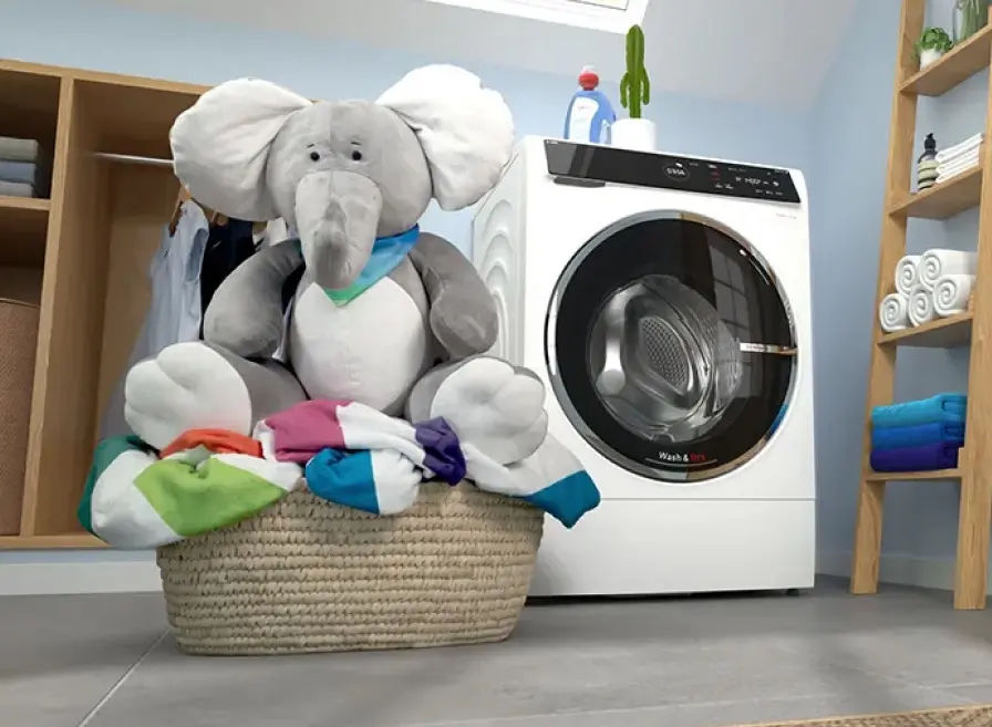 Bosch washer dryer and laundry basket with large plush elephant in it.