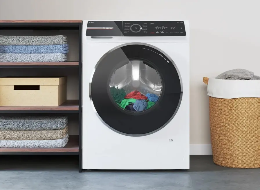 White Bosch washing machine with laundry in it.