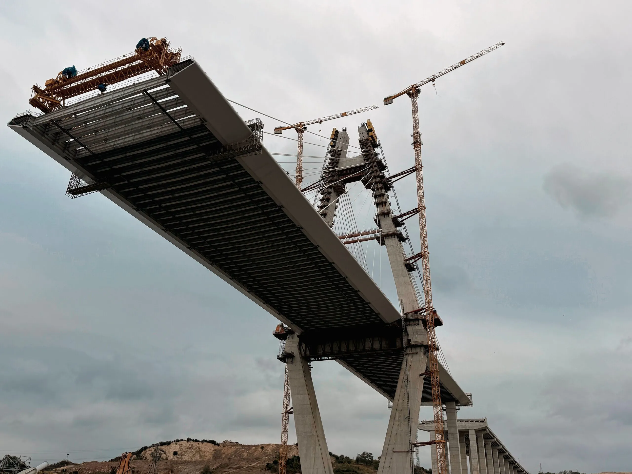 Bridge deck being lifted into place between towers