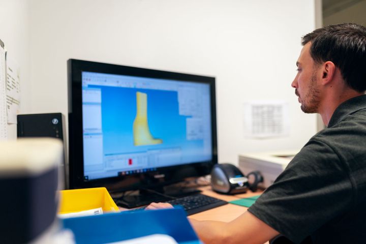 Engineer reviewing a part model on screen