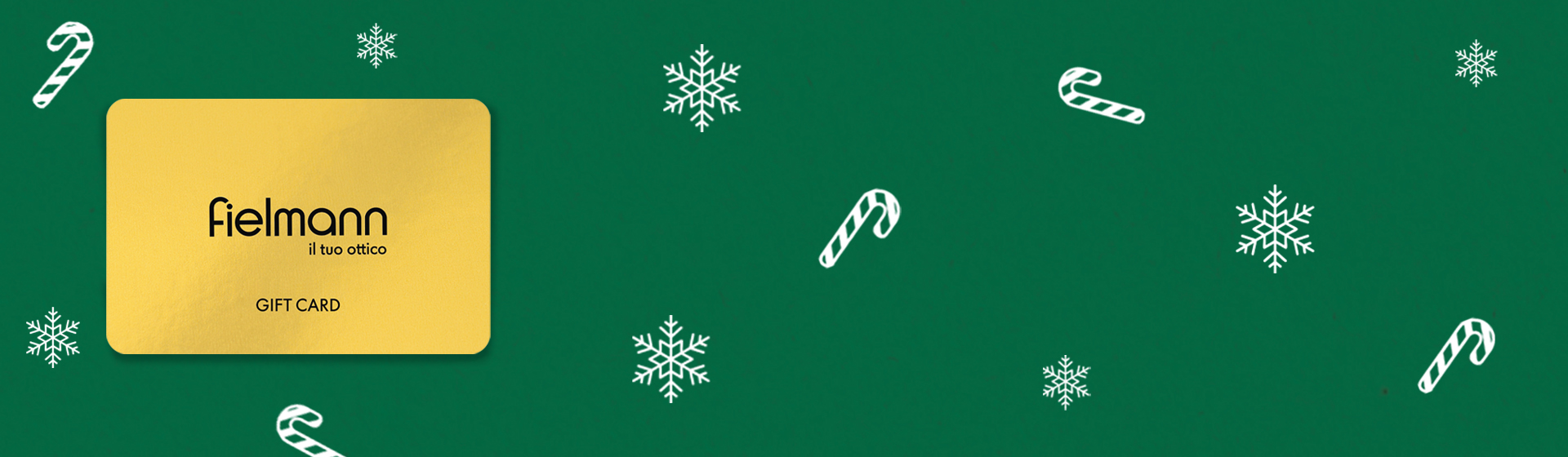 Carta regalo Fielmann color oro su sfondo verde, decorata con bastoncini di zucchero bianchi e fiocchi di neve.