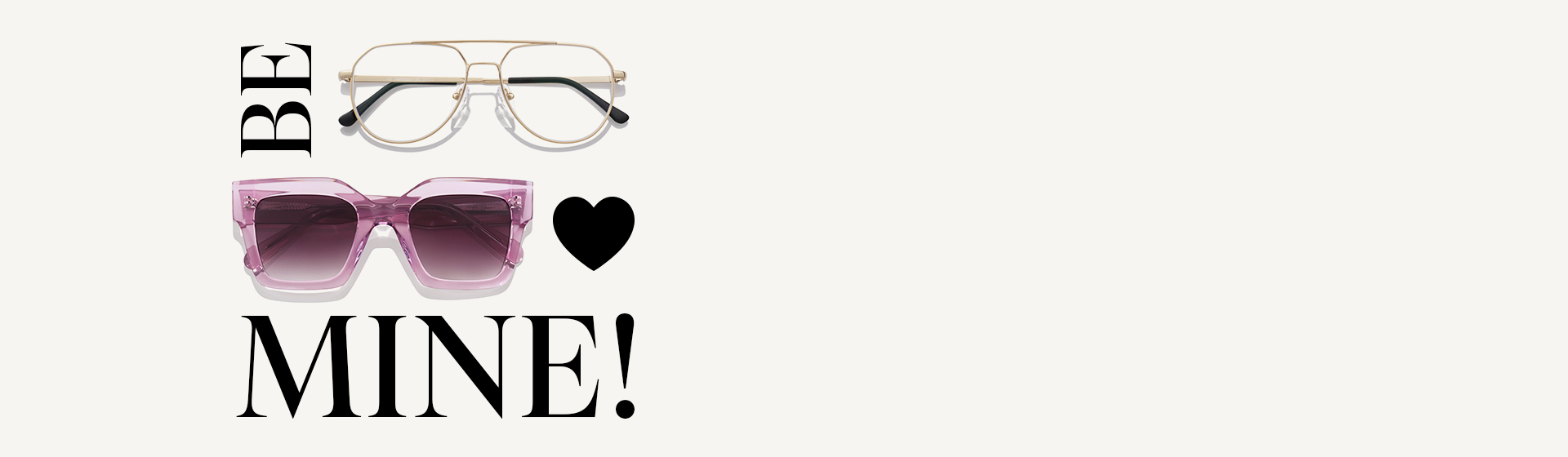 Dvě sluneční brýle, zlaté a růžové, s černým nápisem „BE MINE!” a černým srdcem na bílém pozadí.