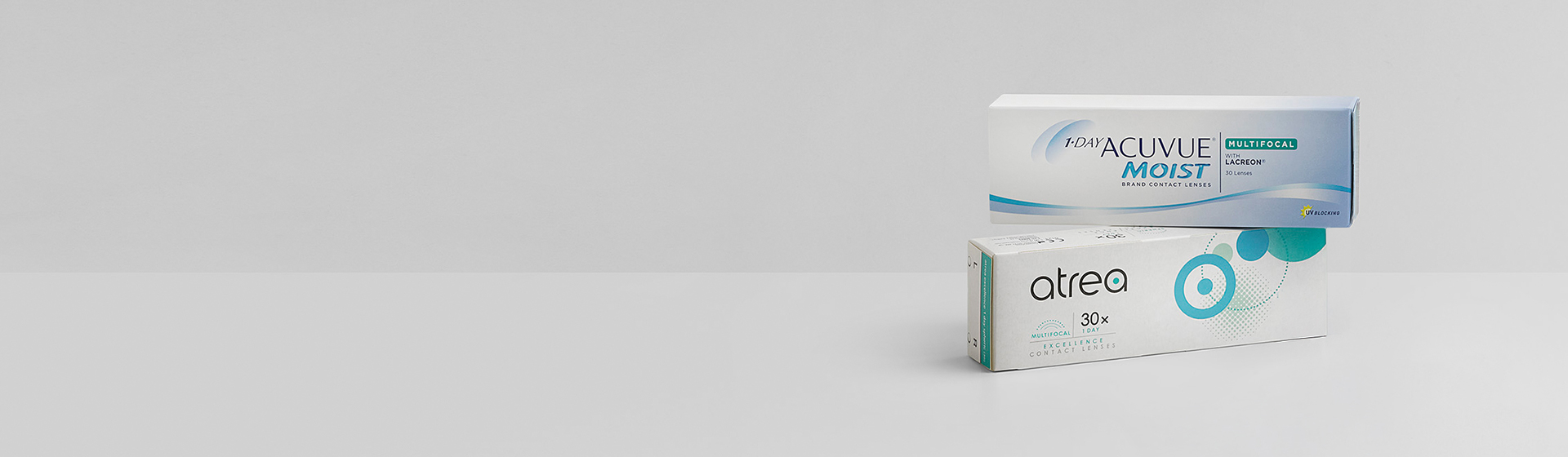 Sfondo grigio su cui sono visibili due prodotti per lenti a contatto.