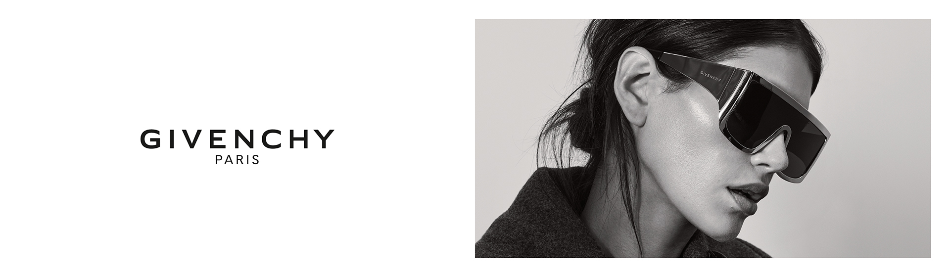 Femme aux cheveux foncés, vêtue d'une veste noire et de gants noirs. Elle porte des lunettes de soleil oversize Givenchy.