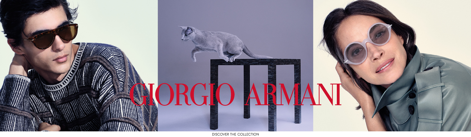 Muž a žena ve stylových slunečních brýlích, uprostřed kočka skáče na stůl. Nápis „Giorgio Armani“ je jasně vidět.