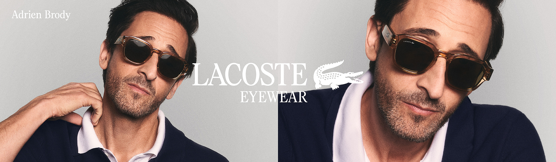 Ein Mann mit Sonnenbrille, der für Lacoste Eyewear modelt, trägt eine dunkle Jacke und ein weißes Hemd vor einem einfarbigen Hintergrund.