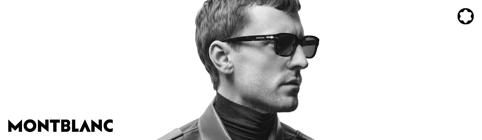 Mann mit Sonnenbrille und Lederjacke, der zur Seite schaut. Montblanc-Logo in der Ecke. Schwarz-Weiß-Bild.
