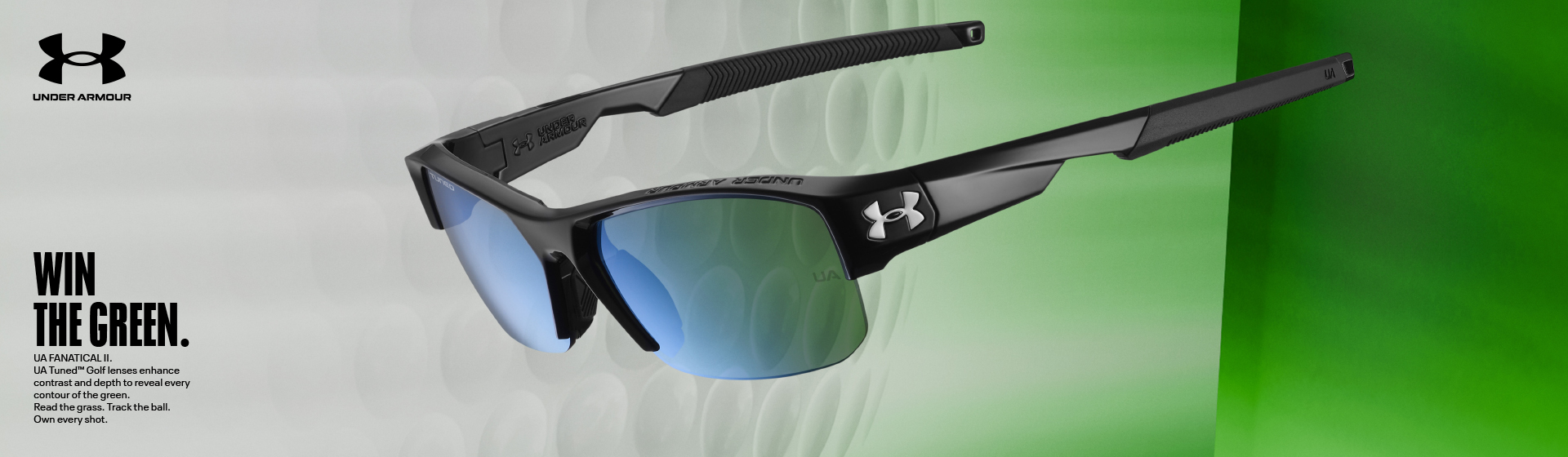 Černé sportovní sluneční brýle s modrými skly na zeleném pozadí s barevným přechodem, s logem Under Armour.