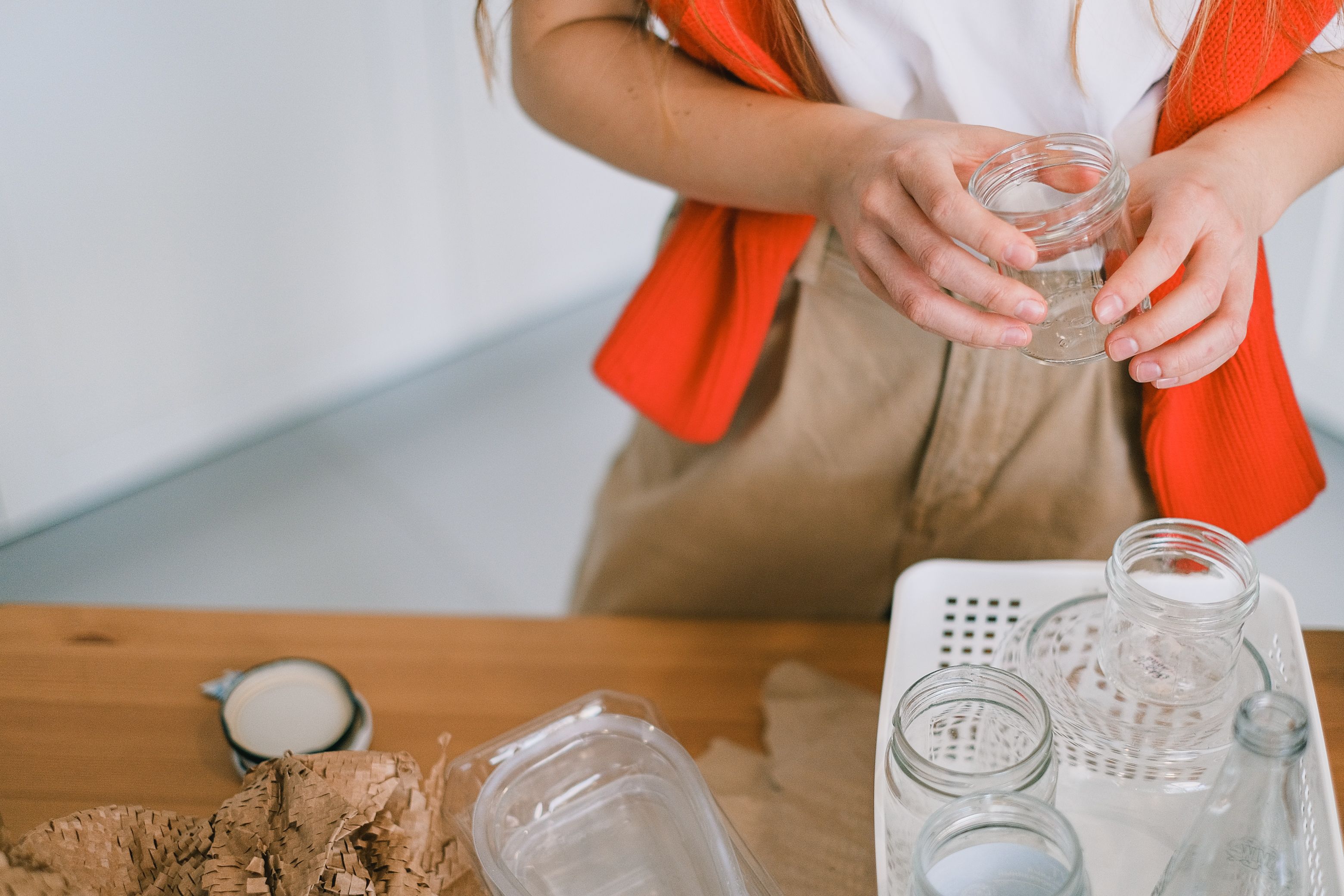a person preparing empty jars as containers