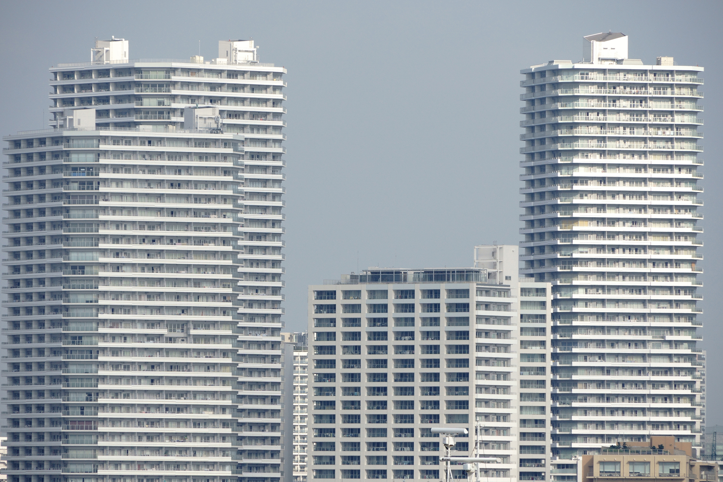 A cityscape with several skyscrapers under a clear sky.
