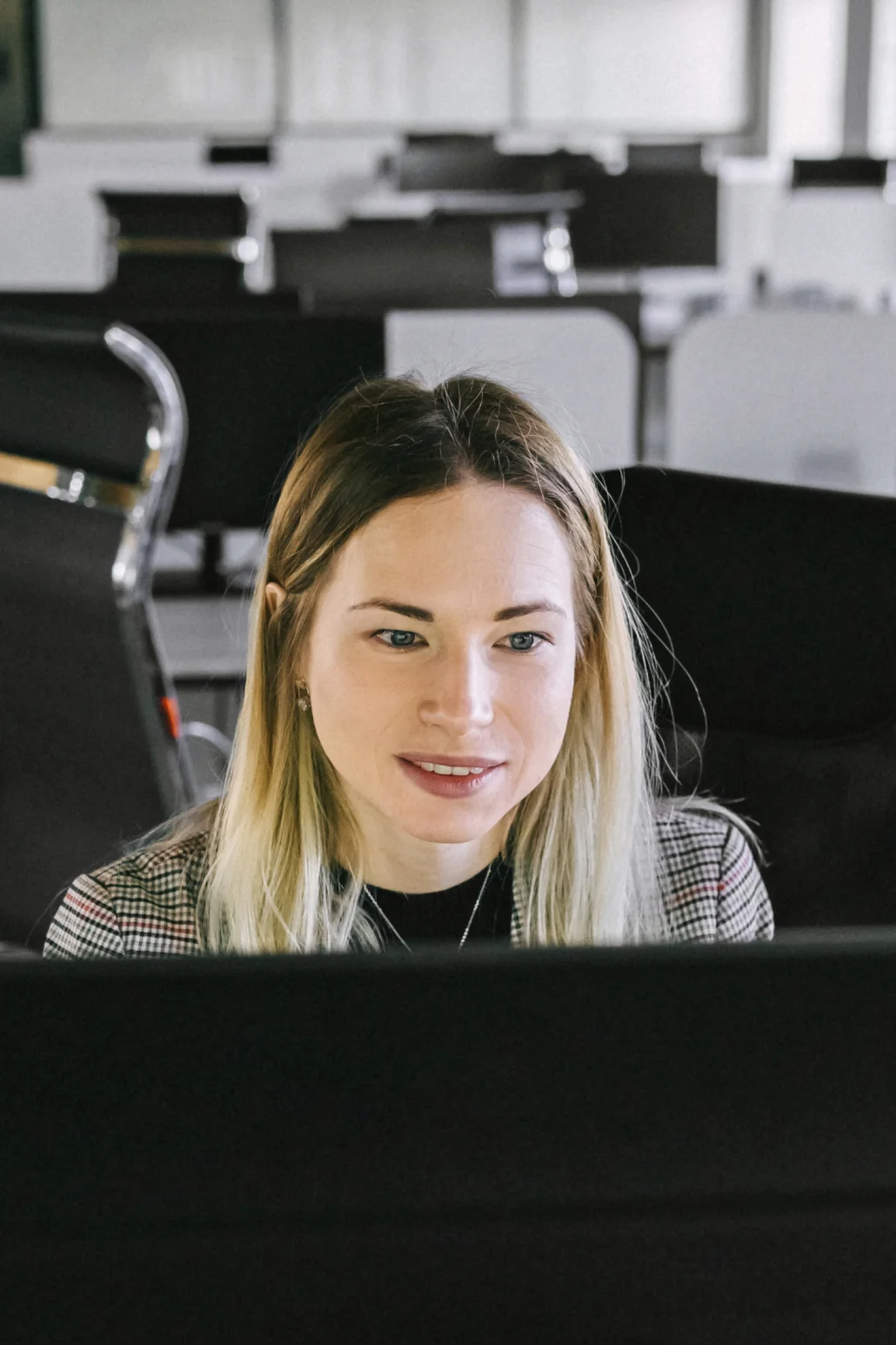 a smiling woman in an office