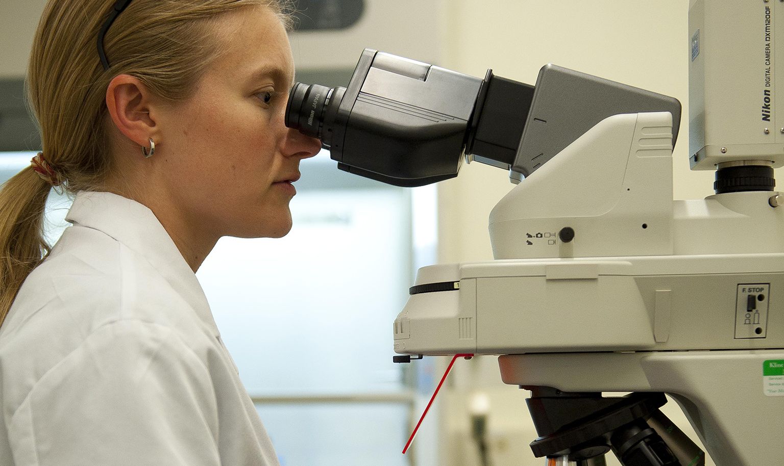 Woman looking into a microscope