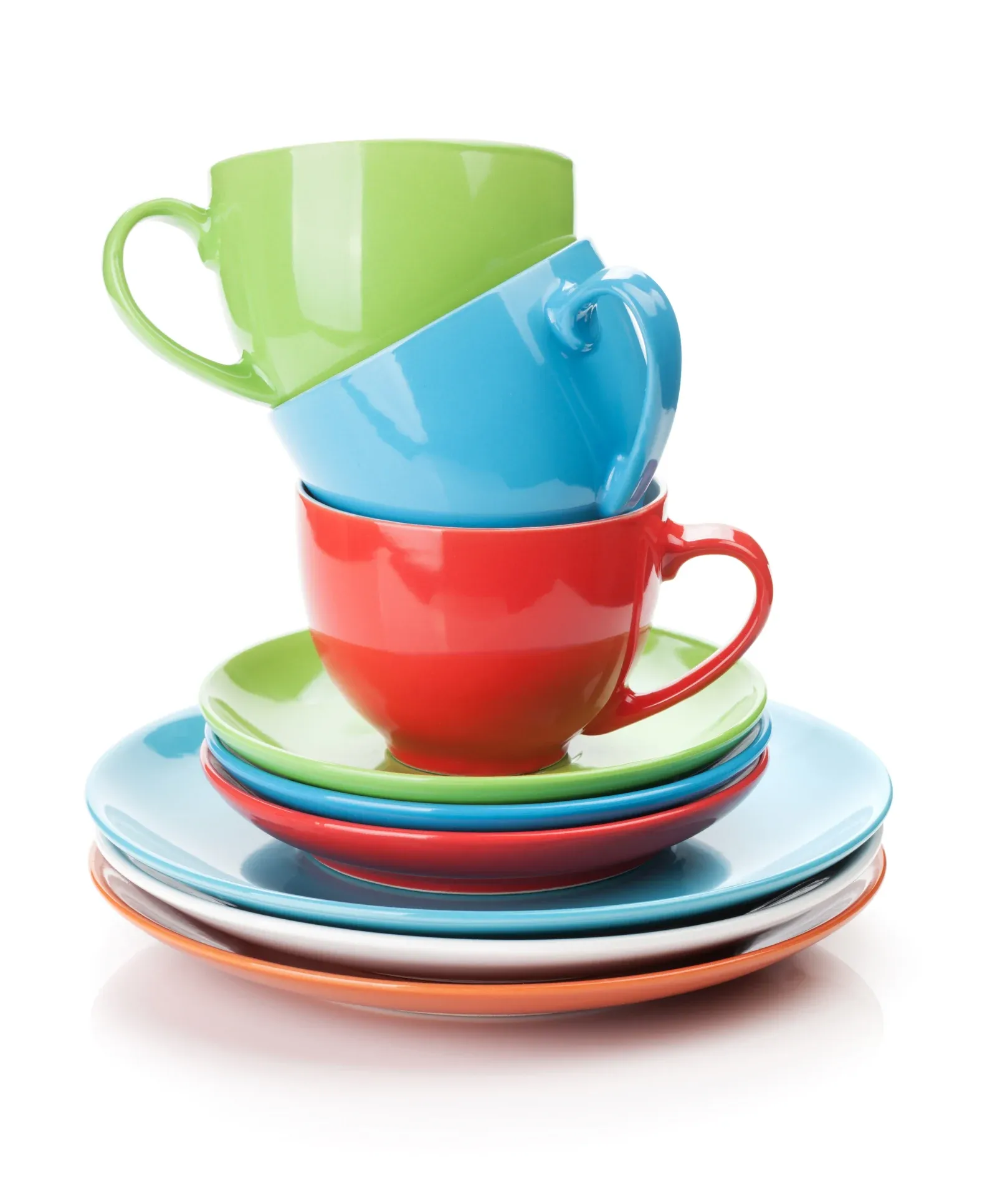 A stack of colorful ceramic cups and saucers, including red, green, blue, and orange, arranged neatly on top of one another.
