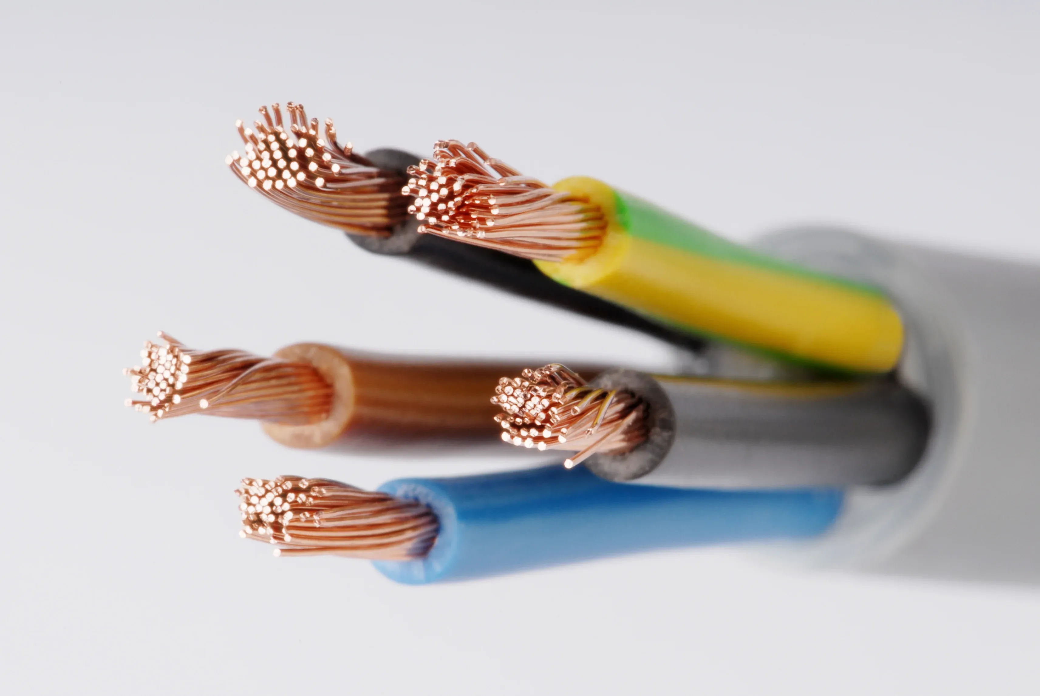Close-up of multiple colored electrical wires with exposed copper ends, including blue, brown, yellow, and gray insulation.