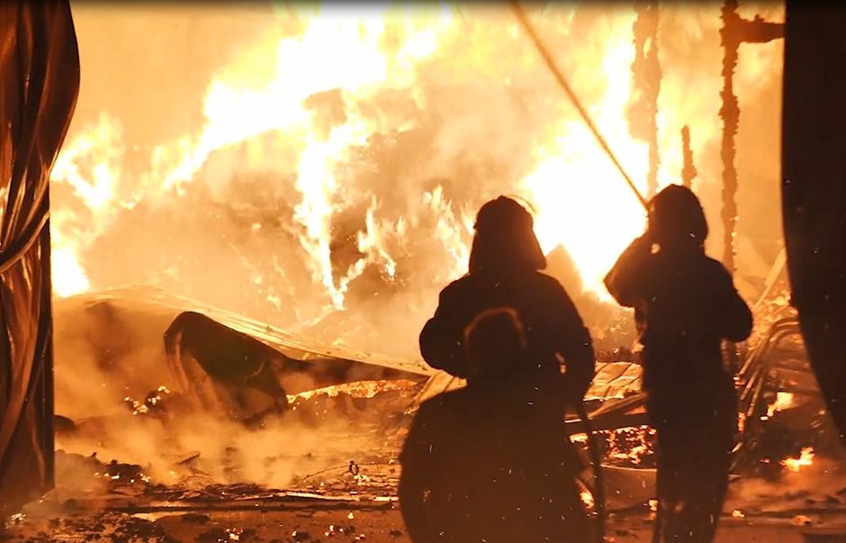 Firemen battle a roaring fire