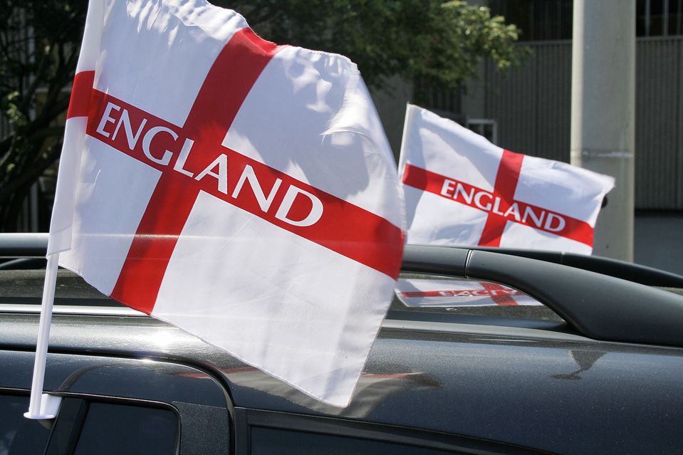 An England flag attached to the roof of a car
