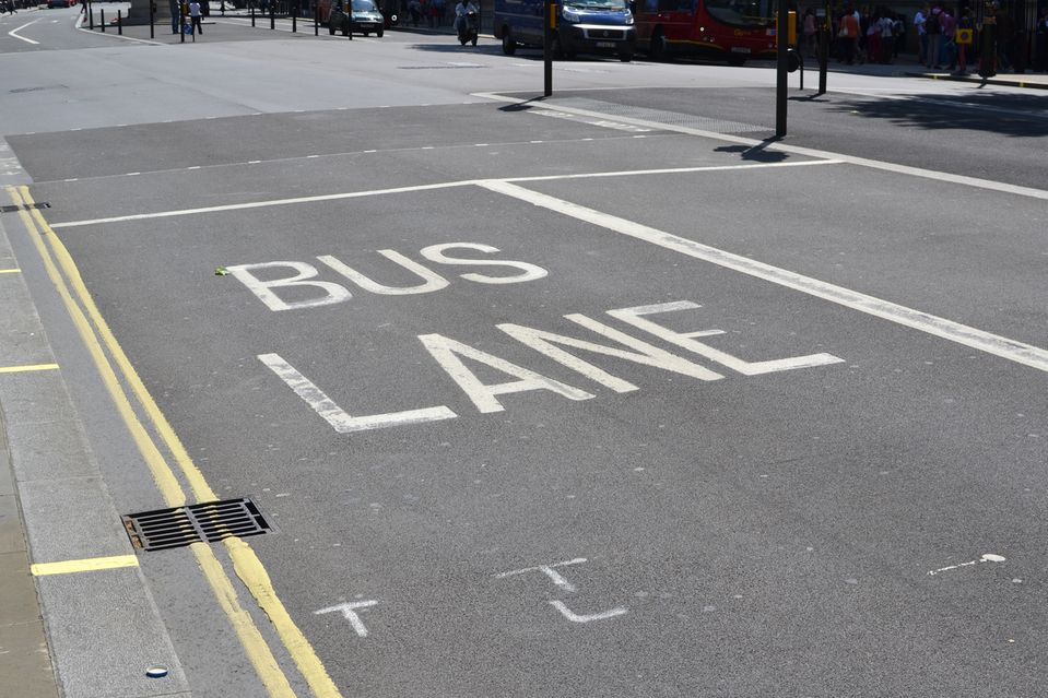 A close up of a bus lane road marking