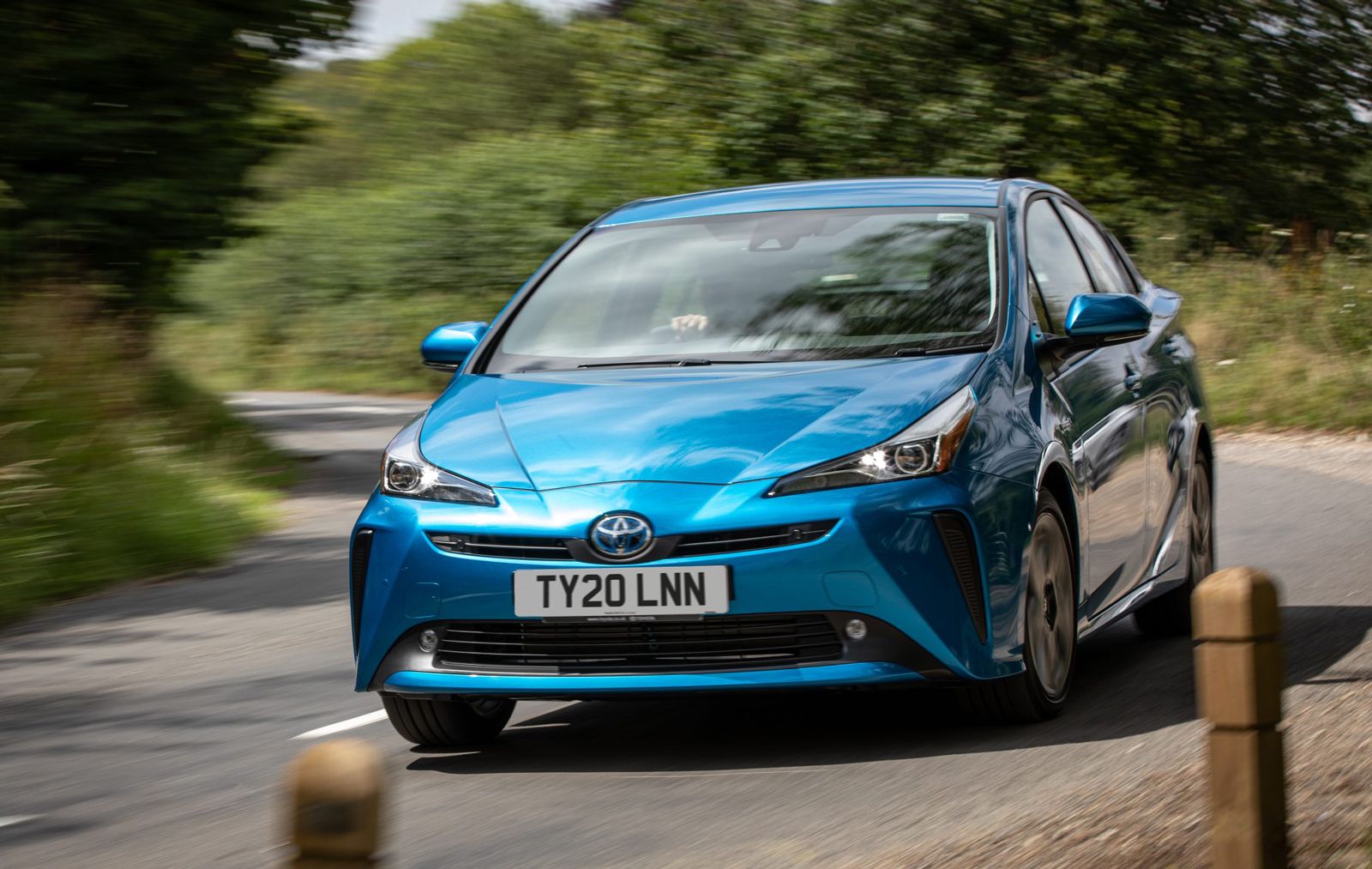 Toyota Prius hybrid car driving on a windy road