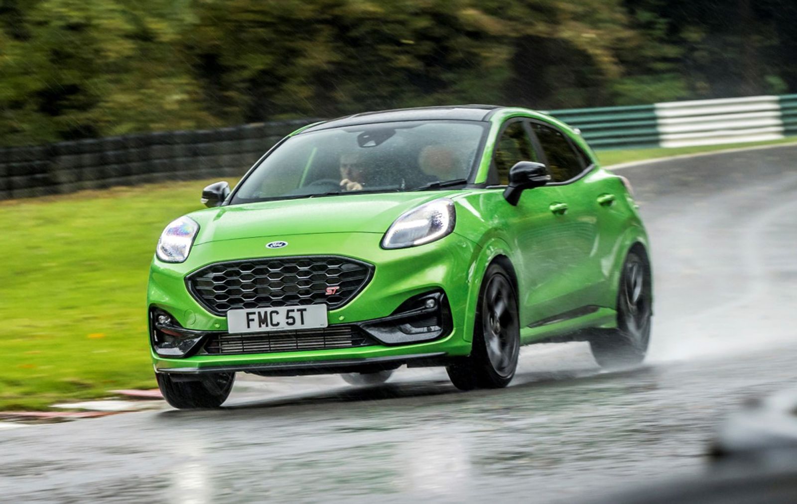 a green ford puma st driving on a racretrack