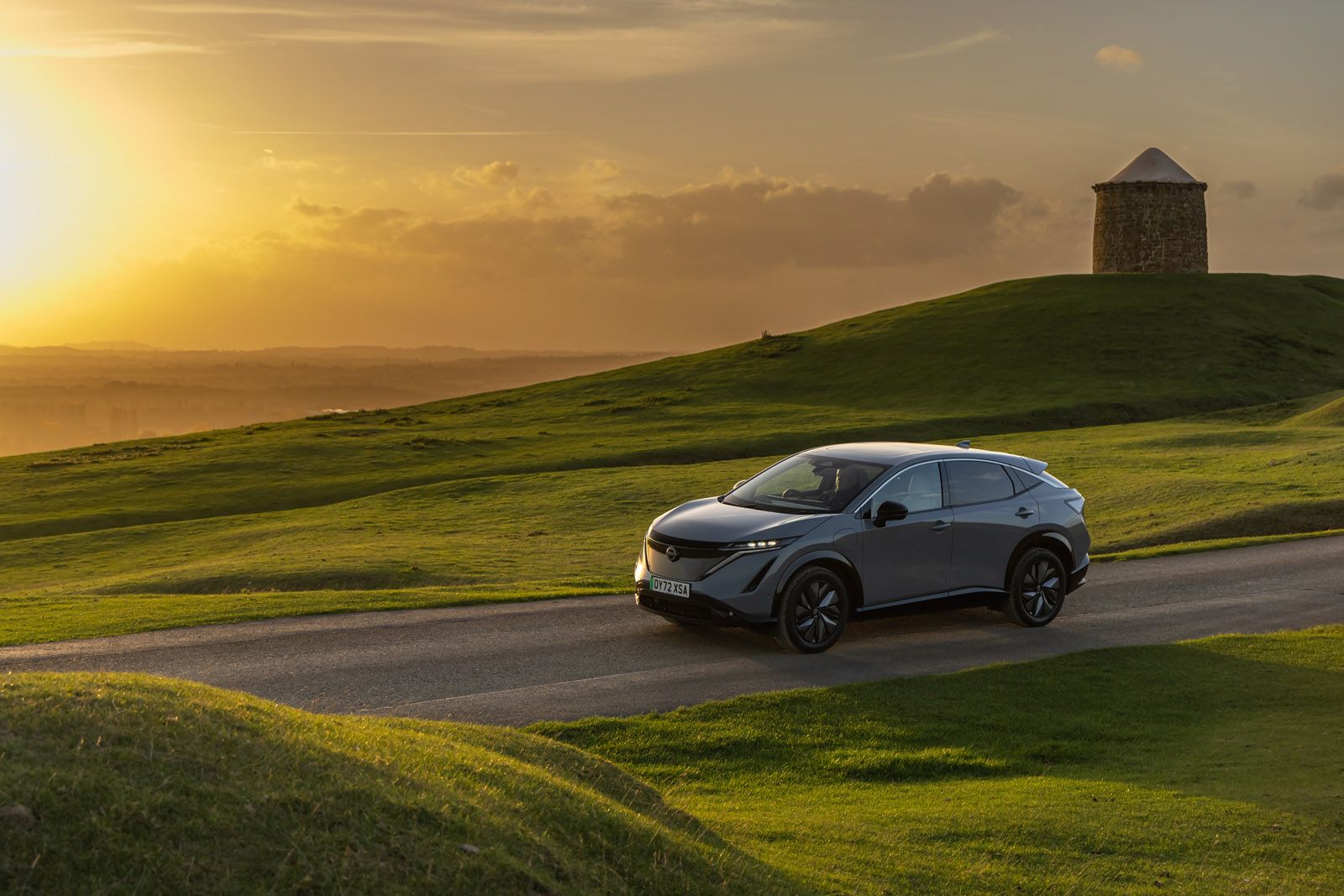 Nissan Ariya driving at sunset