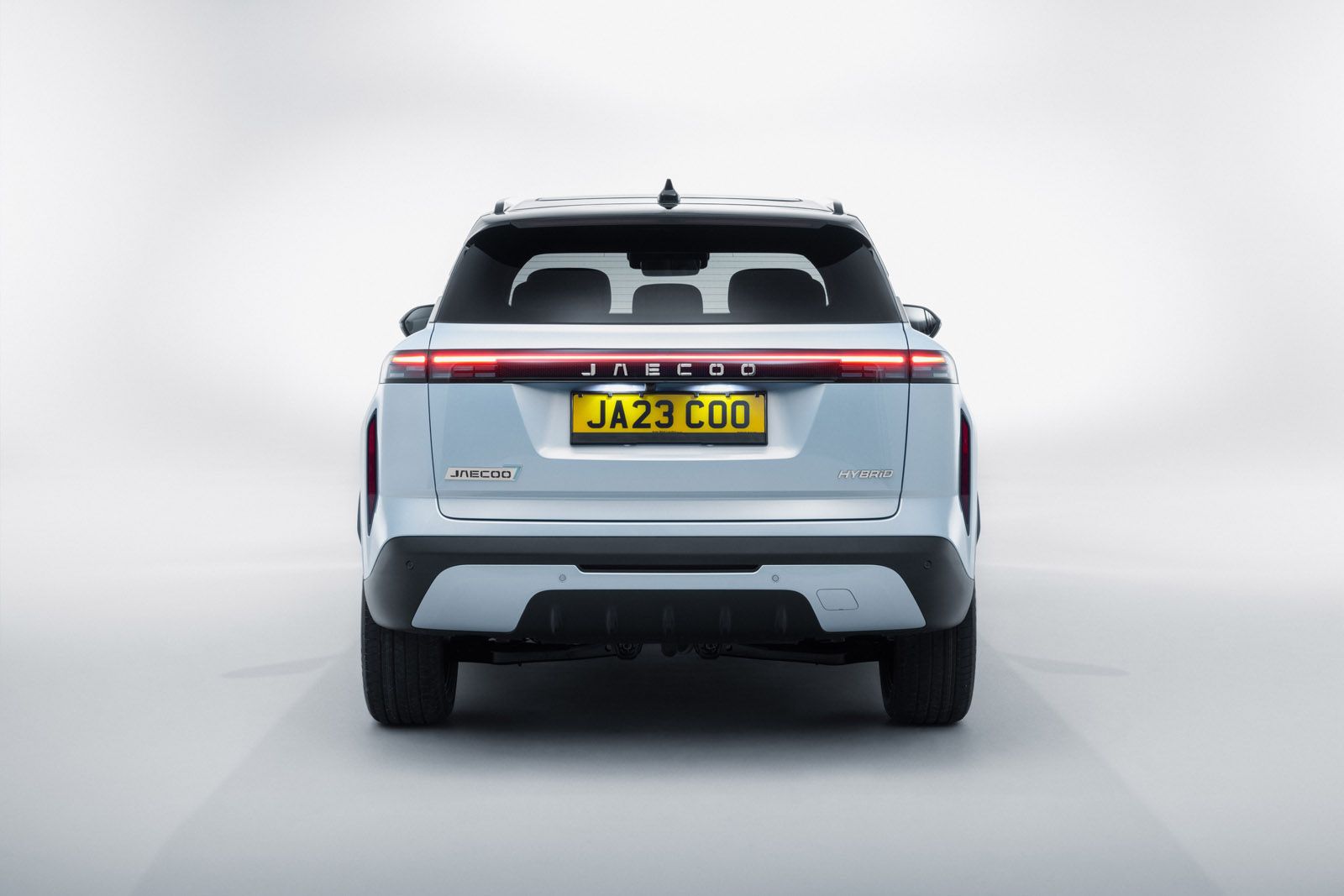 Rear view of a silver SUV with a sleek design, featuring a distinctive tail light pattern and a "JA23 COO" license plate.