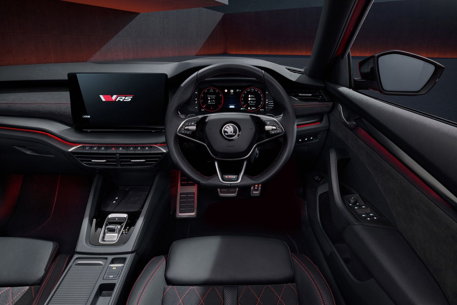 Interior of a modern car featuring a digital dashboard, multifunction steering wheel, and touchscreen display with sporty accents.
