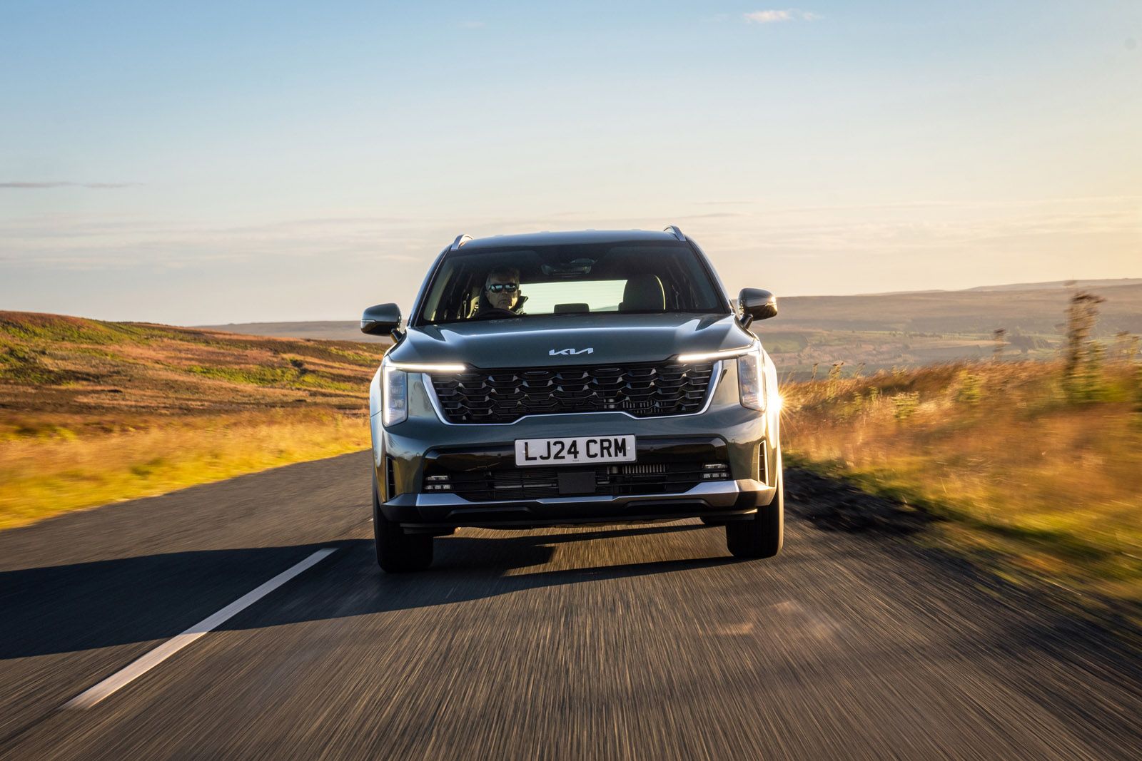 Kia Sorento driving on a country road