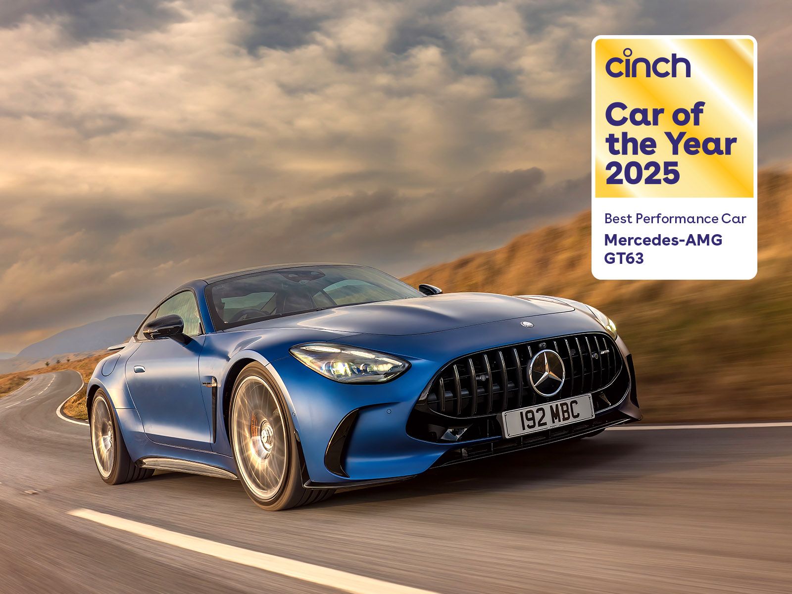 Blue Mercedes-AMG GT63 driving on a winding road with a "Car of the Year 2025" award badge in the top right corner.